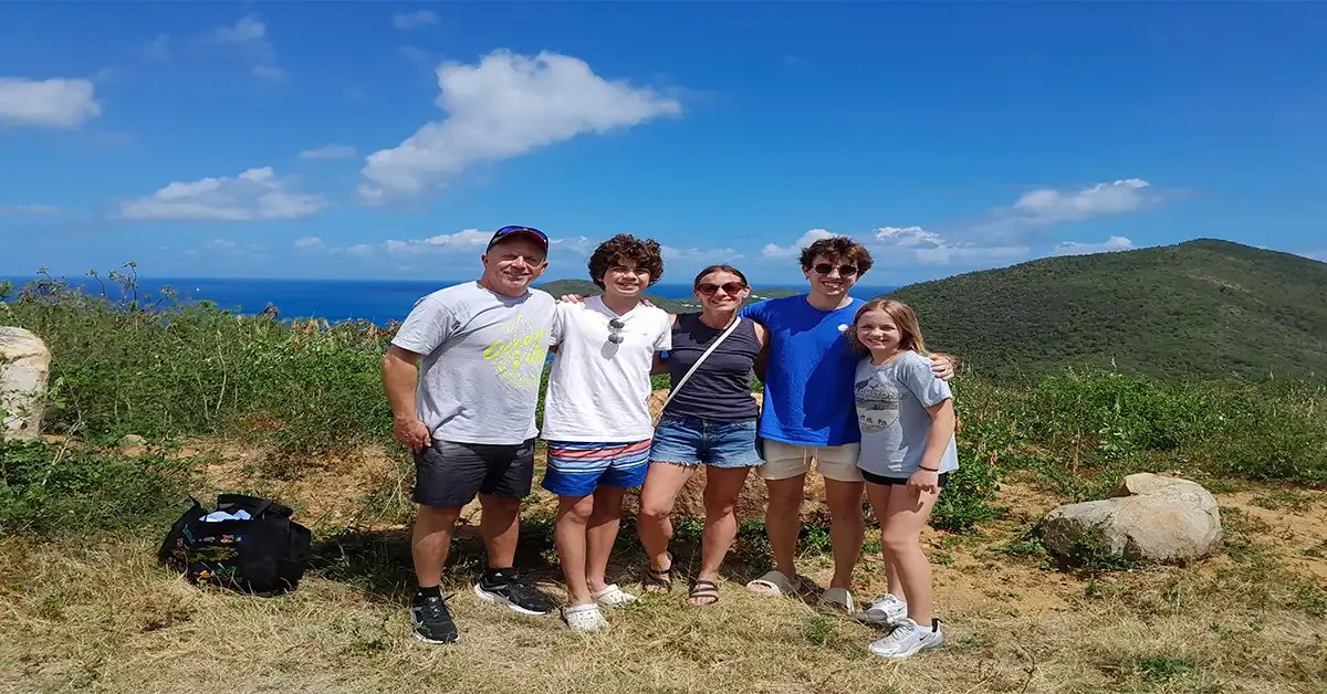 Family posing together during a Yo Yo Mr. Taxi island day.