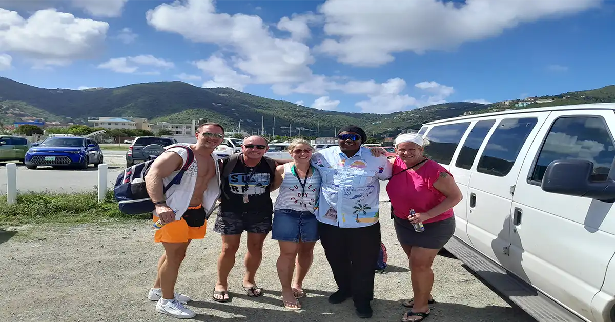 A taxi driver with guests after a ride in the British Virgin Islands.